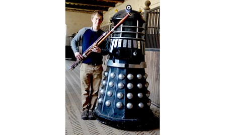 A photograph of Oliver Ludlow, Director and Bassoon Specialist at Double Reed Ltd., standing with an authentic BBC 'Dalek' from the TV show 'Dr Who'